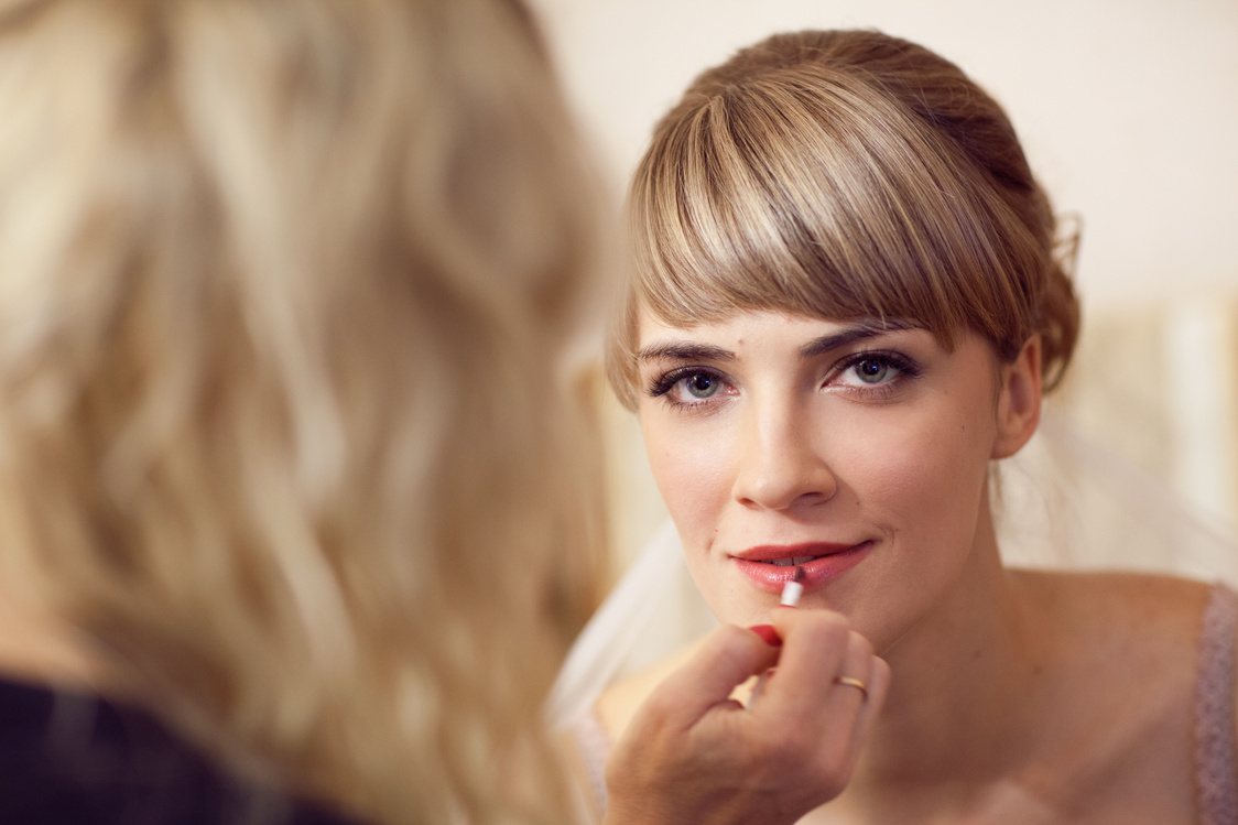 girl applying wedding make-up by professional make-up artist