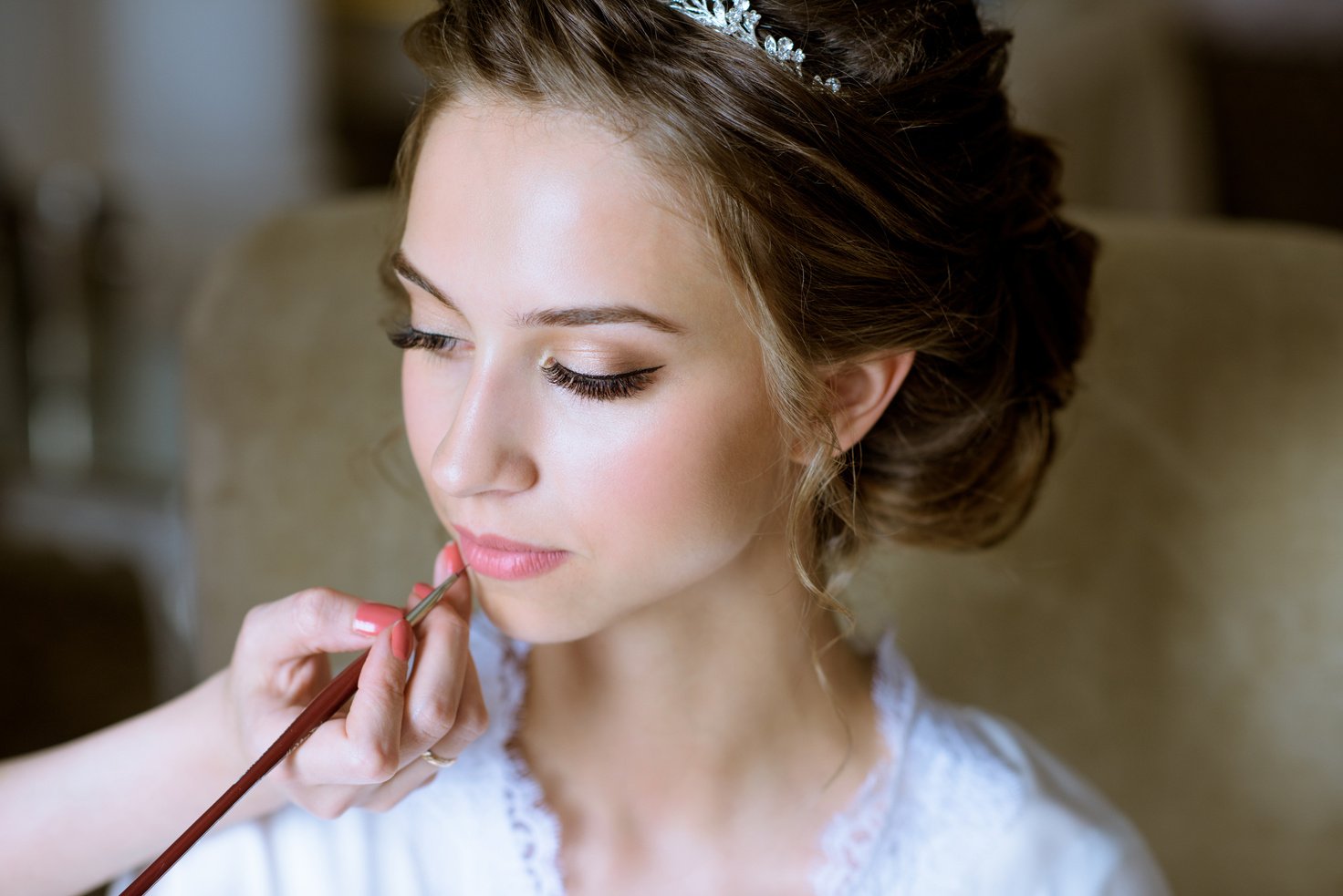 Wedding makeup artist making a make up for bride